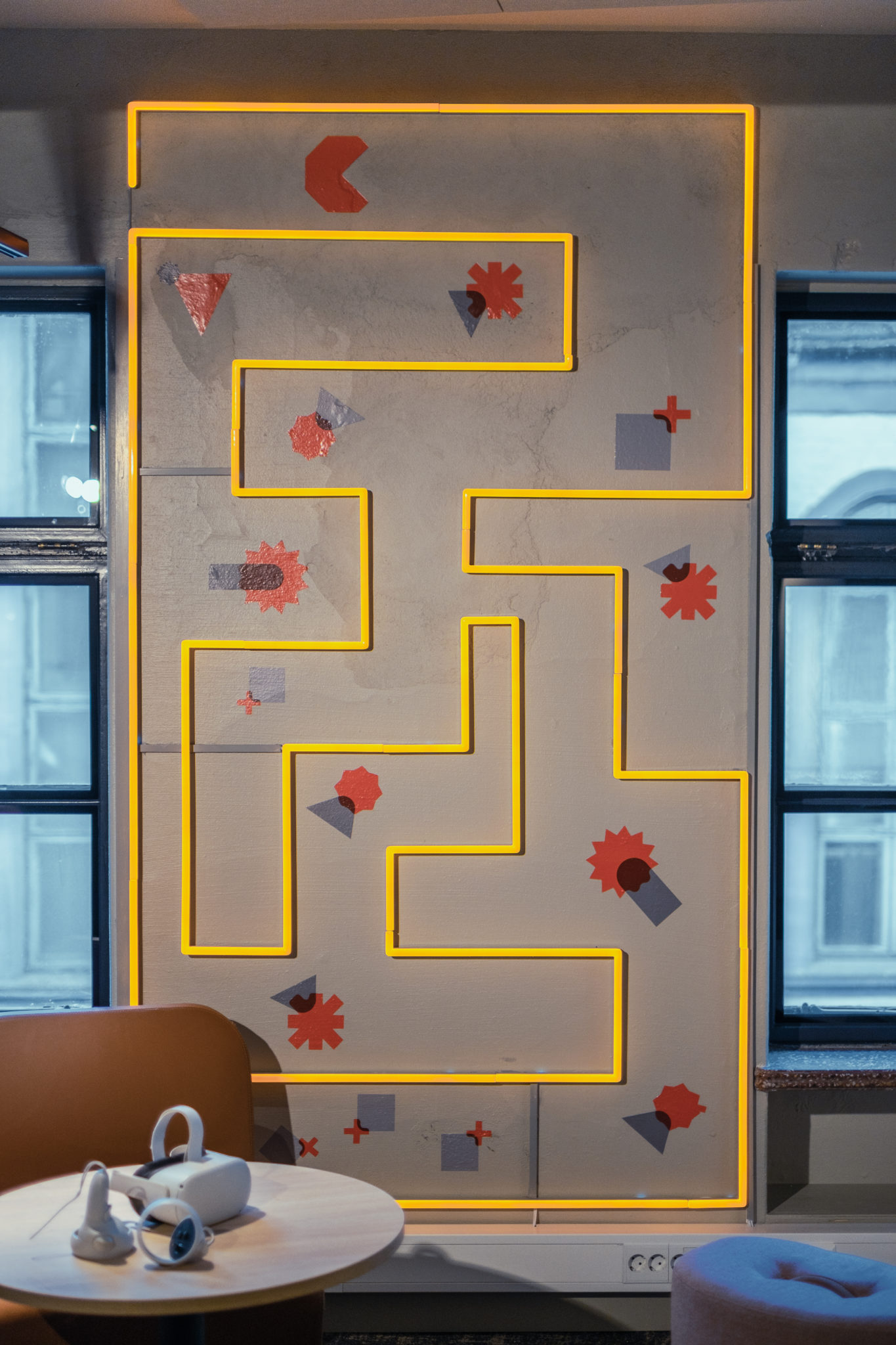 Foto av dekor i kontoret til dRofus, som viser grafiske former og neonlys. Det kan minne om spillet pacman.